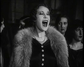 Female Civilian Singing Scales Badly Whilst Other Female Civilian is Playing the Piano in..., 1920s. Creator: British Pathe Ltd.