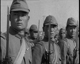 Close up of Male Japanese Soldiers Standing to Attention and Holding Their Bayonets Looking..., 1938 Creator: British Pathe Ltd.