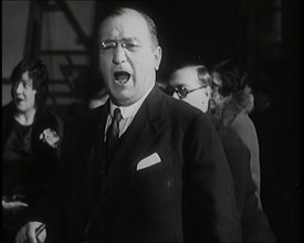 Female Civilian Singing Scales Badly Whilst Other Female Civilian is Playing the Piano in..., 1920s. Creator: British Pathe Ltd.