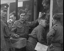 British Soldiers Receiving Food and Drinks on Trains Taking Them To Camp, 1940. Creator: British Pathe Ltd.