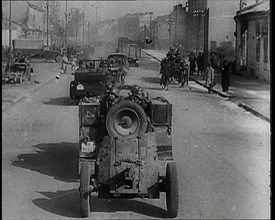 German Army Vehicles With Male Soldiers in Them Driving Down a Street in Warsaw Past..., 1939. Creator: British Pathe Ltd.