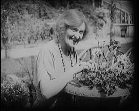 The Actress Sybil Thorndike Tending Her Flowers in a Garden, 1920s. Creator: British Pathe Ltd.