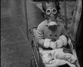 A Young Child in a Pram Wearing a Gas Mask, 1939. Creator: British Pathe Ltd.