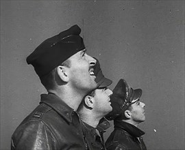 A Group of Male Pilots Watching Aircraft in the Sky, 1943-1944. Creator: British Pathe Ltd.