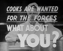 Two Cooks With a Recruitment Slogan on the Screen, 1942. Creator: British Pathe Ltd.