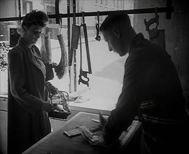 A Woman Buying Meat at a Butcher's Shop, 1942. Creator: British Pathe Ltd.