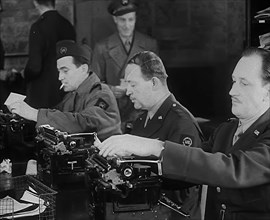 Uniformed Journalists Working, 1943. Creator: British Pathe Ltd.