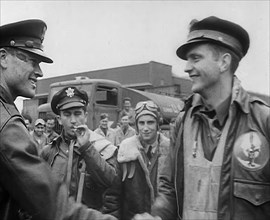 A Male Pilot Shaking Hands with an Officer, whilst other Pilots are Looking On, 1943-1944. Creator: British Pathe Ltd.