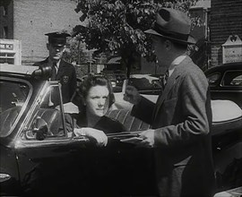 An Official Checking a Petrol Ration Card in Washington, District of Columbia, 1942. Creator: British Pathe Ltd.