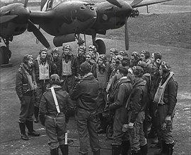 A Group of Male Pilots Talking in Front of an Aircraft, 1943-1944. Creator: British Pathe Ltd.