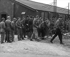 American Airmen Queueing up Outside a Building at an Airfield in England, 1943-1944. Creator: British Pathe Ltd.