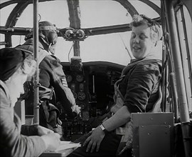 Women and a Pilot Sitting in the Cockpit of a Plane, 1942. Creator: British Pathe Ltd.