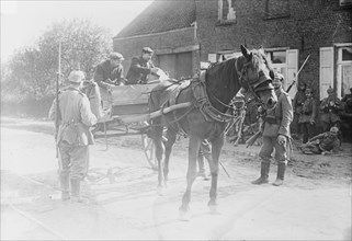 Belgian peasants showing pass to sentries, between 1914 and c1915. Creator: Bain News Service.