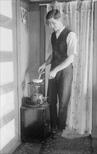 At Broad Channel - the oil stove, between c1910 and c1915. Creator: Bain News Service.