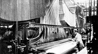 Weaving three-yard-wide quilts: a large jacquard loom in use, 1909. Creator: Unknown.