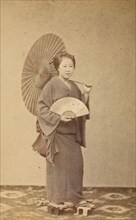 Woman with parasol and fan, about 1868. Creator: Felice Beato.