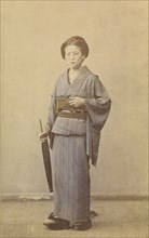 Woman with closed parasol, about 1868. Creator: Felice Beato.