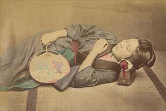 Sleeping Japanese woman holding a fan, 1868-1880. Creator: Felice Beato.