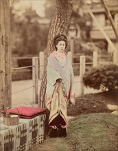 Girl standing near tree, 1870s-1890s. Creator: Kusakabe Kimbei.