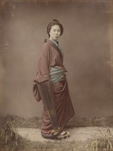 Woman with Closed Umbrella, 1870s-1890s. Creator: Kusakabe Kimbei.