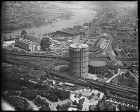 Battersea Power Station under construction and the Gas Holder Station, Nine Elms, London, c1930s. Creator: Arthur William Hobart.