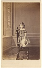 Little girl standing on a chair, 1865-1875. Creator: Frederick Downer & Sons.