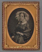 Portrait of a middle-aged woman wearing wire-rimmed glasses in flower embellished veil, 1855-1860. Creator: James McClees.