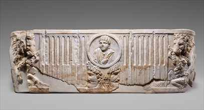 Front of a Sarcophagus with Female Portrait in a Medallion above Two Theatrical Masks...250-275. Creator: Unknown.