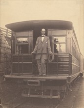 Portrait of an unidentified man standing on rear platform of a train, about 1863. Creator: Unknown.