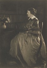 Self-portrait with Table and Flowers, 1896-1899. Creator: Gertrude Kasebier.