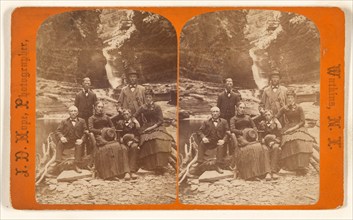 Family group portrait, posed in natural setting on rocks, 1868-1878. Creator: James Douglas Hope.