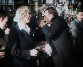 A British Woman and a British Man Standing at  the Bar Holding Drinks in a Public House..., 1939. Creator: British Pathe Ltd.