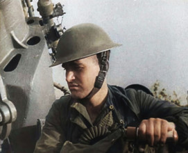 Close up of a Male British Soldier Wearing a Steel Helmet and Sitting Next to an Anti-Air..., 1939. Creator: British Pathe Ltd.