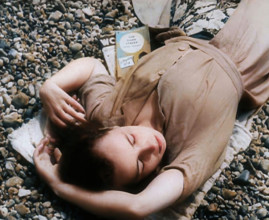 A Young Woman Lying on the Beach at  Brighton With Her Eyes Closed With a Two Books to the..., 1939. Creator: British Pathe Ltd.