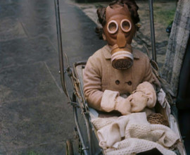 A Young Child in a Pram Wearing a Gas Mask, 1939. Creator: British Pathe Ltd.