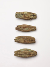 Four peg-like objects, perhaps imitations of canine teeth, 1200-1400. Creator: Unknown.