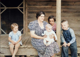 Wife and children of tobacco sharecropper on front porch, Person County, North Carolina, 1939. Creator: Dorothea Lange.