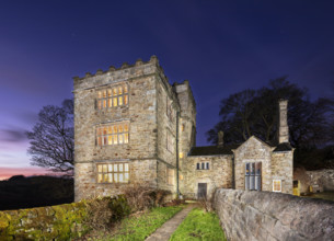 Exterior view, taken using a drone at sunset, showing North Lees Hall from the south-east with the