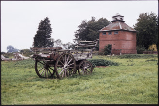 The dovecote to the south-west of Kentwell Hall seen with an old wooden wagon in the foreground,