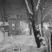 The graveyard of Highgate School Chapel covered in snow, 1971; looking towards the junction of