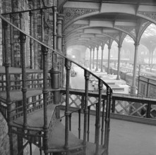 Interior of Liverpool Street Station showing a cast iron spiral staircase, 1960-1972. Visible in