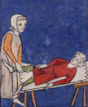A woman setting a bone in a boy's leg, 14th century. The boy lies back on a table while the woman