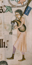 A bagpiper, c1300-c1340. His cheek is puffed out with the effort of playing the instrument. The