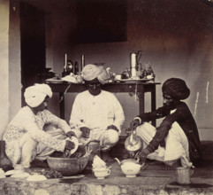 Three Indian domestic servants at work, 1870s. Washing up and making tea.