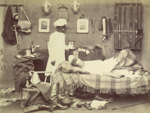 Indian servant and master, 1870s. European being waited on by a young man bringing tea.