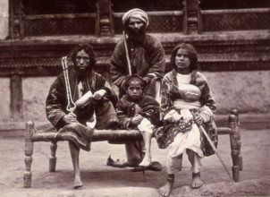Group of beggars sitting on a charpoy, Kabul, Afghanistan, c1880.