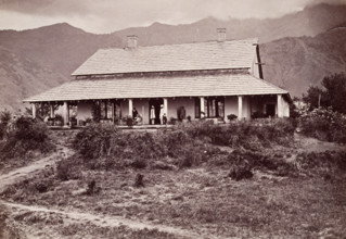 Tea estate bungalow at Sumali, 1860s. European man and children on the verandah, with Indian