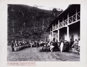 Weighing of tea leaves at a tea plantation, c1920. Women pickers wait with their baskets, as a