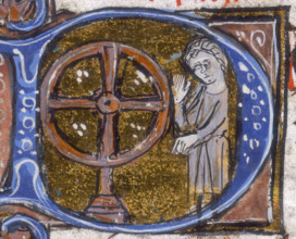 A wheel of fortune, early 14th century. The wheel is associated with fate and chance. From a