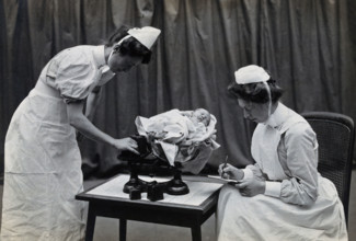 General Lying In Hospital, York Road, Lambeth: nurses weighing a baby, 1906 Creator: Unknown.